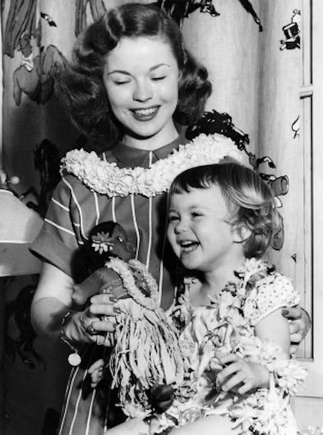 A heartwarming image of the legendary child star Shirley Temple with her beloved daughter Linda, showcasing the love and bond they shared